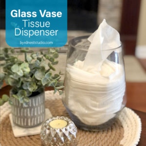 DIY glass vase tissue dispenser on table with plant and candle