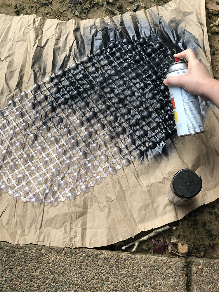 spray paint the plastic bathmat