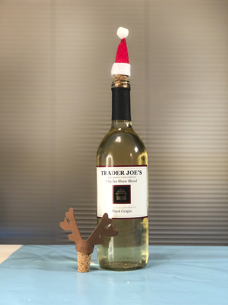 Santa hat cork on wine bottle
