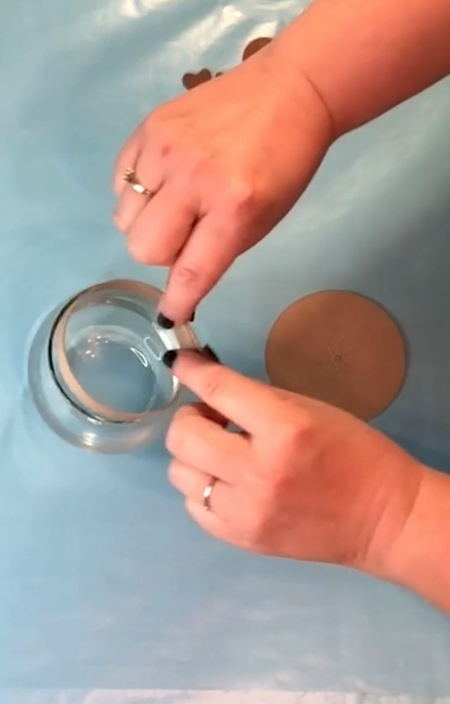 bend strip into a ring and make sure it fits loosely into the opening of the wine glass opening