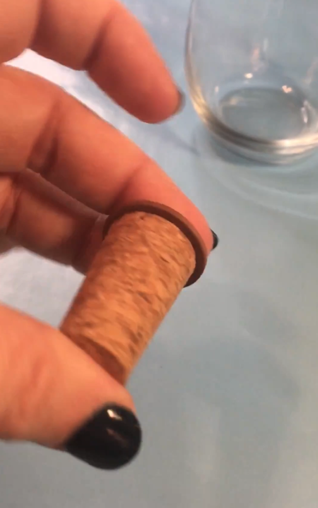 glue circle to the wider end of the cork