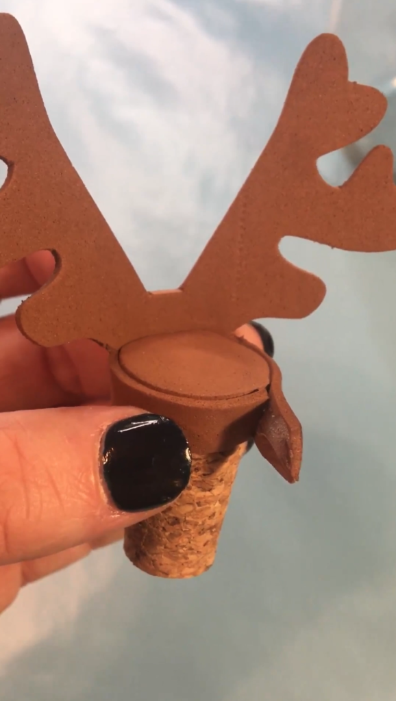 Glue the antlers to the wider end of the cork
