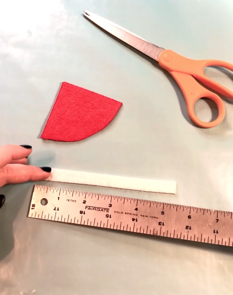 Cut out a .5" x 5.5" strip of white felt using your scissors